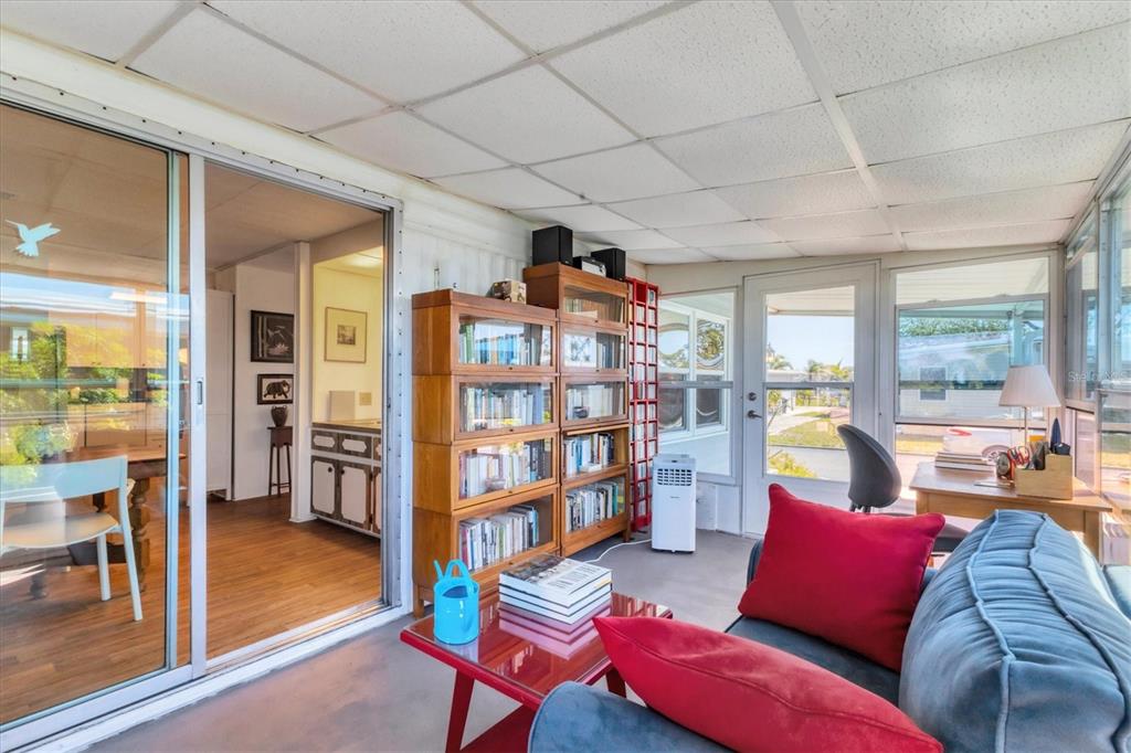 985 Jolanda Circle Venice, FL 34285 - Photo 18 of 49 a living room with furniture and a floor to ceiling window