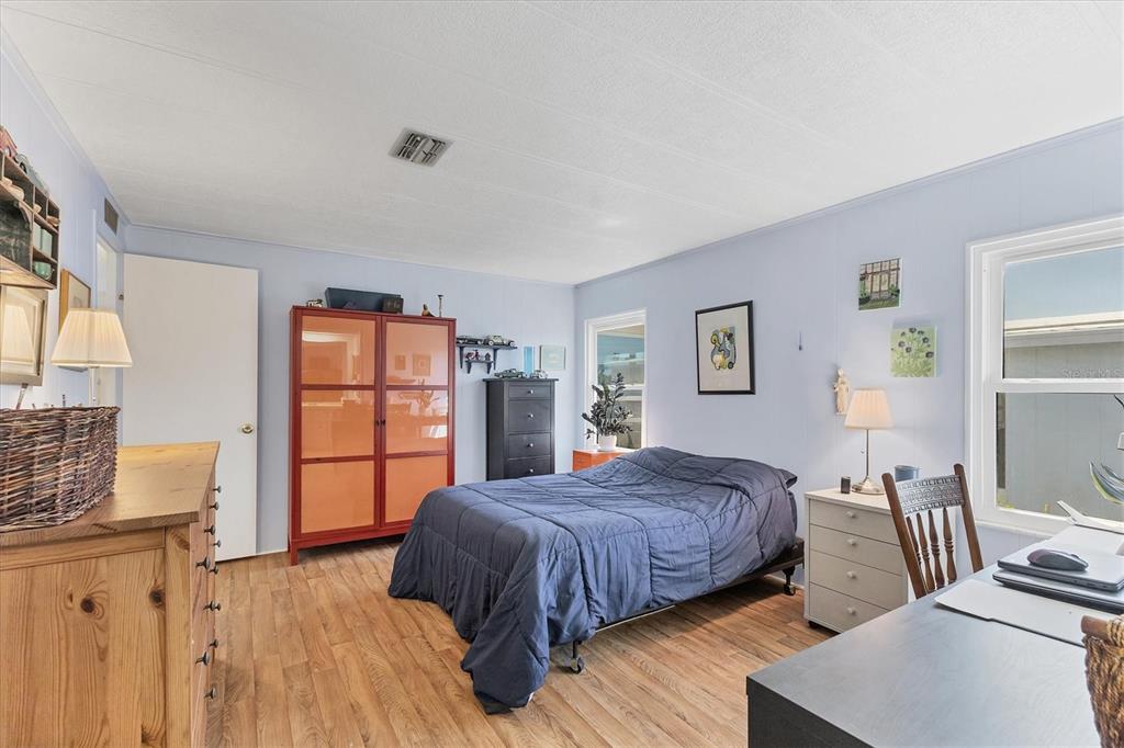 985 Jolanda Circle Venice, FL 34285 - Photo 20 of 49 a bedroom with a bed and wooden floor