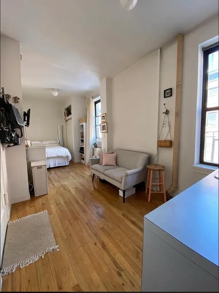 214 Mulberry Street, Unit 4C Manhattan, NY 10012 - Photo 1 of 1 a living room with furniture and wooden floor