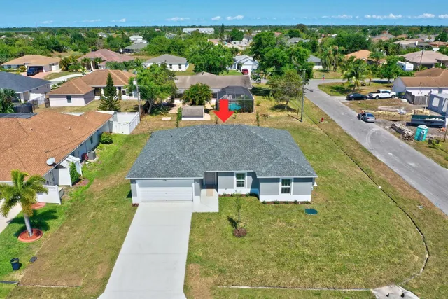 an aerial view of residential houses with outdoor space and street view