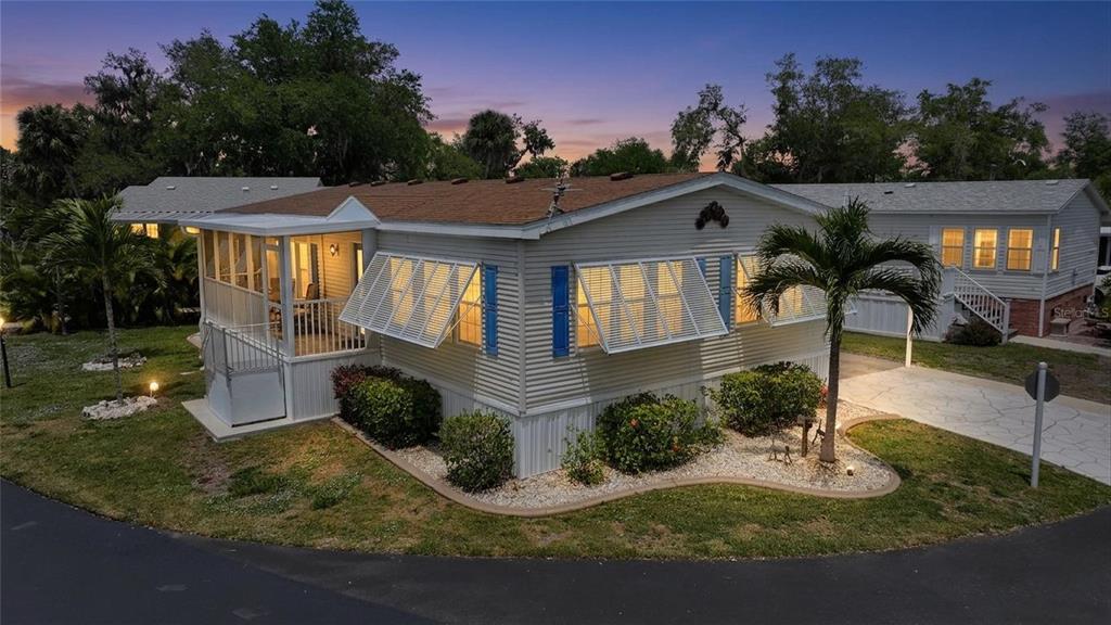 10303 Burnt Store Road, Unit 143 Punta Gorda, FL 33950 - Photo 2 of 42 a front view of a house with garden