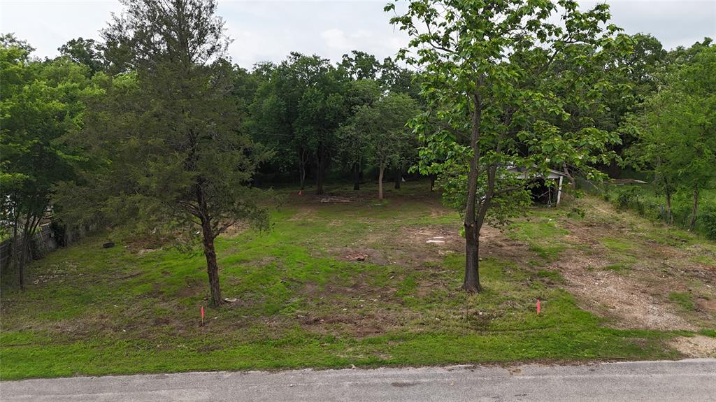 7151 Alcove Street Azle, TX 76020 - Photo 2 of 15 a backyard of a house with lots of green space