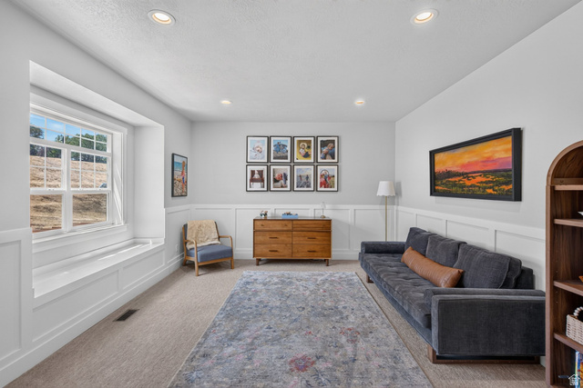 1263 East 1200th South Springville, UT 84663 - Photo 41 of 60 Spacious room featuring a large window with a built-in window seat, wainscoting details, recessed lighting, and a neutral carpet