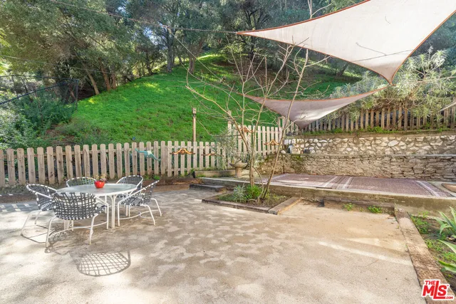 a view of a balcony with wooden floor and fence