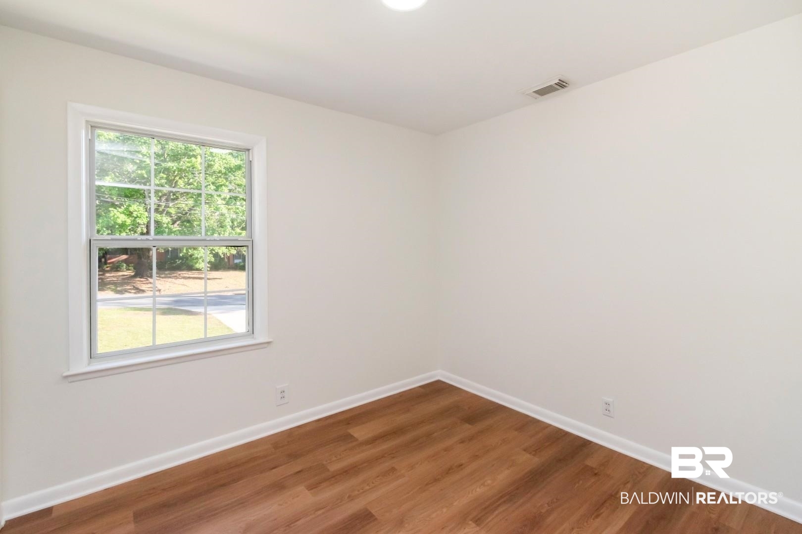 115 Pineridge Road Daphne, AL 36526 - Photo 21 of 34 Unfurnished room featuring baseboards, wood finished floors, and visible vents