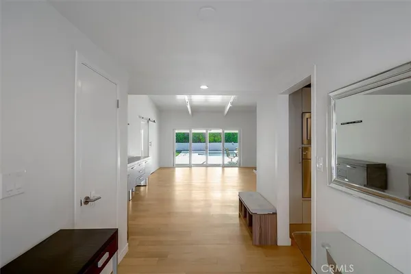 a view of an empty room with a fireplace and a window
