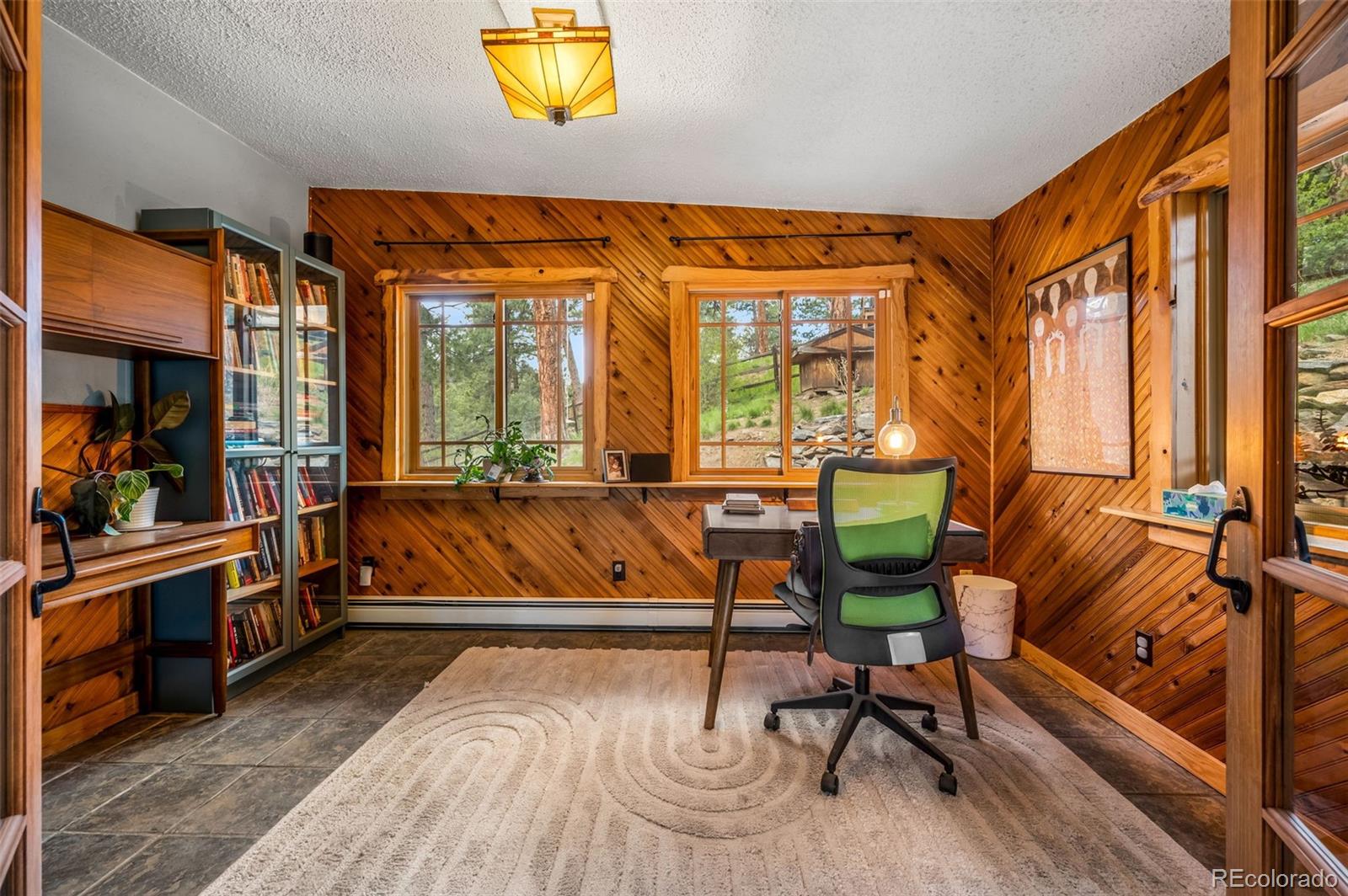30315 Lone Spruce Road Evergreen, CO 80439 - Photo 11 of 48 a living room with a couch and a table