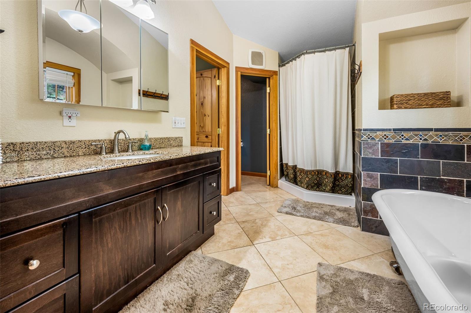 30315 Lone Spruce Road Evergreen, CO 80439 - Photo 15 of 48 a kitchen with a sink and a refrigerator
