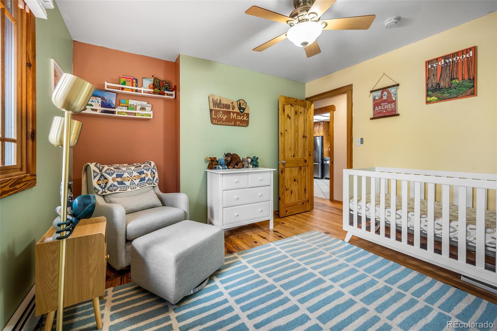 30315 Lone Spruce Road Evergreen, CO 80439 - Photo 18 of 48 a bedroom with furniture and a chandelier