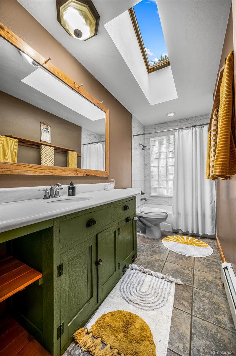 30315 Lone Spruce Road Evergreen, CO 80439 - Photo 19 of 48 a bathroom with a sink mirror and a bathtub