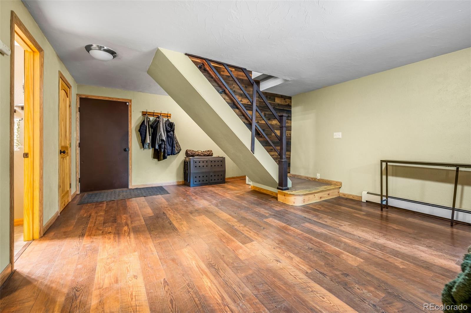 30315 Lone Spruce Road Evergreen, CO 80439 - Photo 23 of 48 a view of a room with wooden floor and stairs