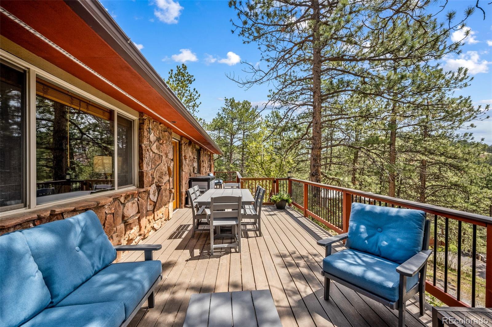 30315 Lone Spruce Road Evergreen, CO 80439 - Photo 30 of 48 a balcony with wooden floor and furniture