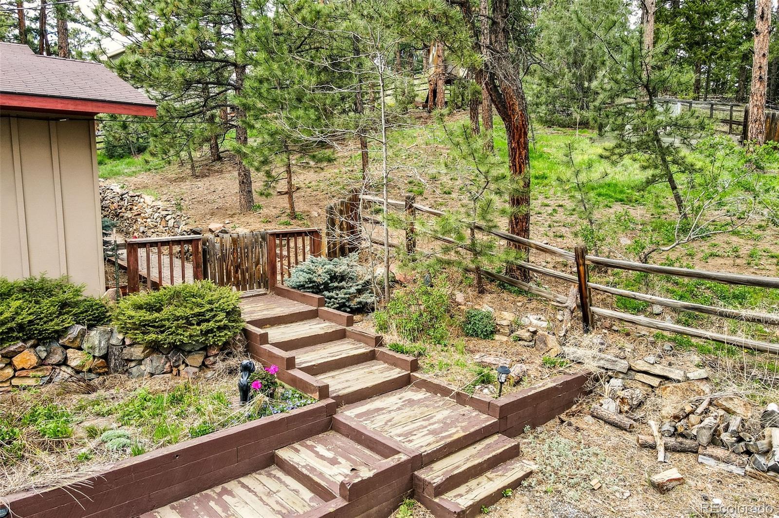 30315 Lone Spruce Road Evergreen, CO 80439 - Photo 32 of 48 a garden view with a seating space