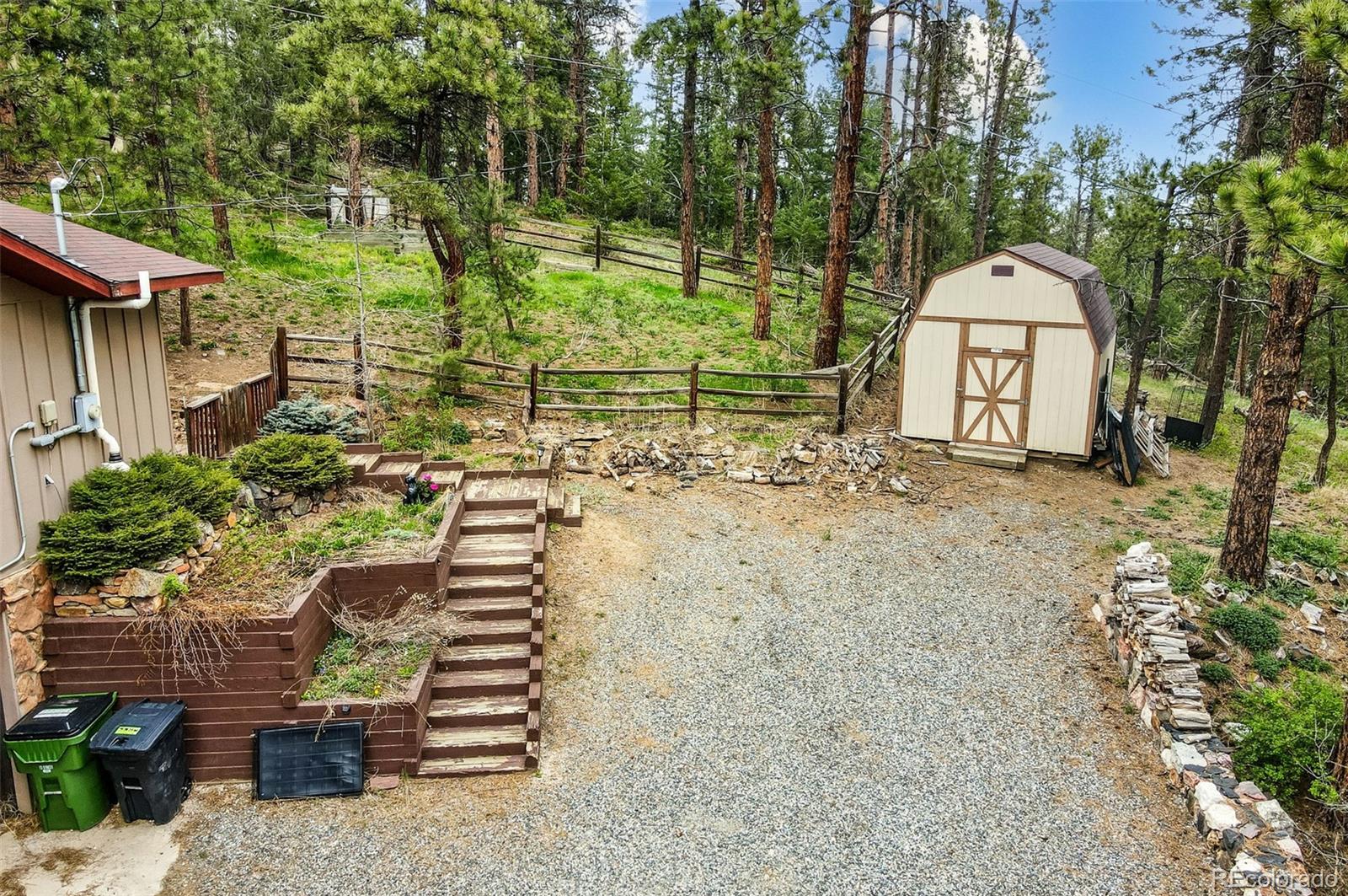 30315 Lone Spruce Road Evergreen, CO 80439 - Photo 40 of 48 a backyard of a house with lots of green space