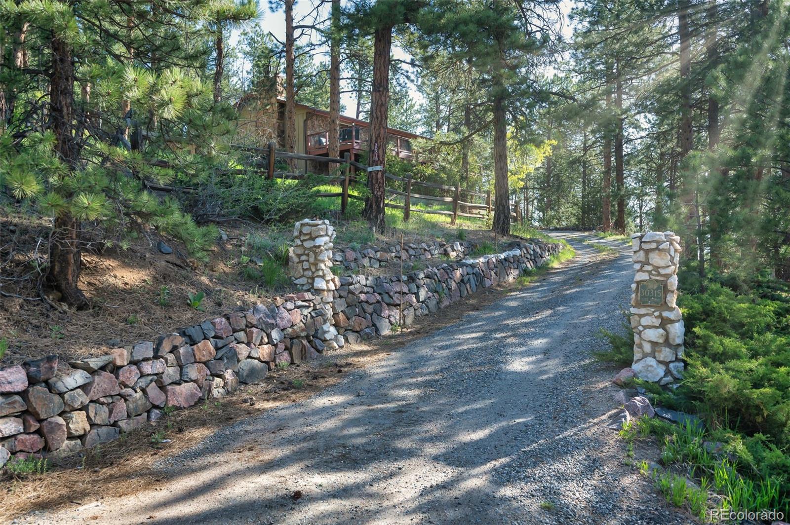 30315 Lone Spruce Road Evergreen, CO 80439 - Photo 46 of 48 a view of a house with a yard