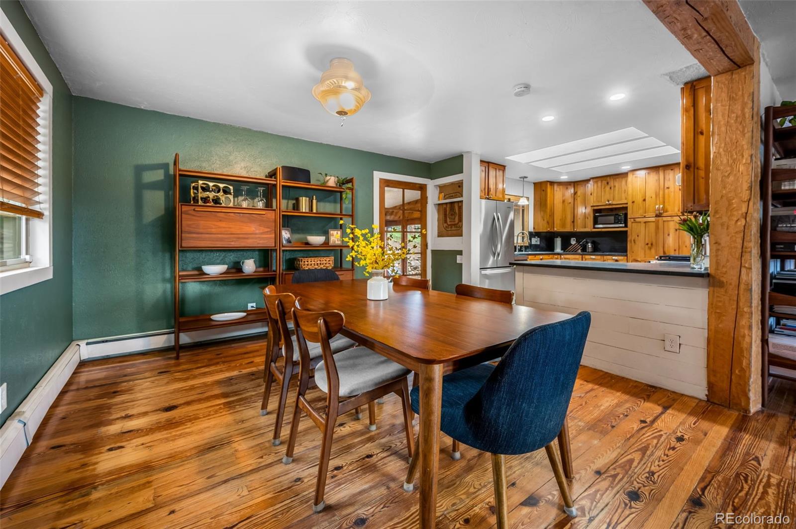30315 Lone Spruce Road Evergreen, CO 80439 - Photo 7 of 48 a dining room with furniture and wooden floor