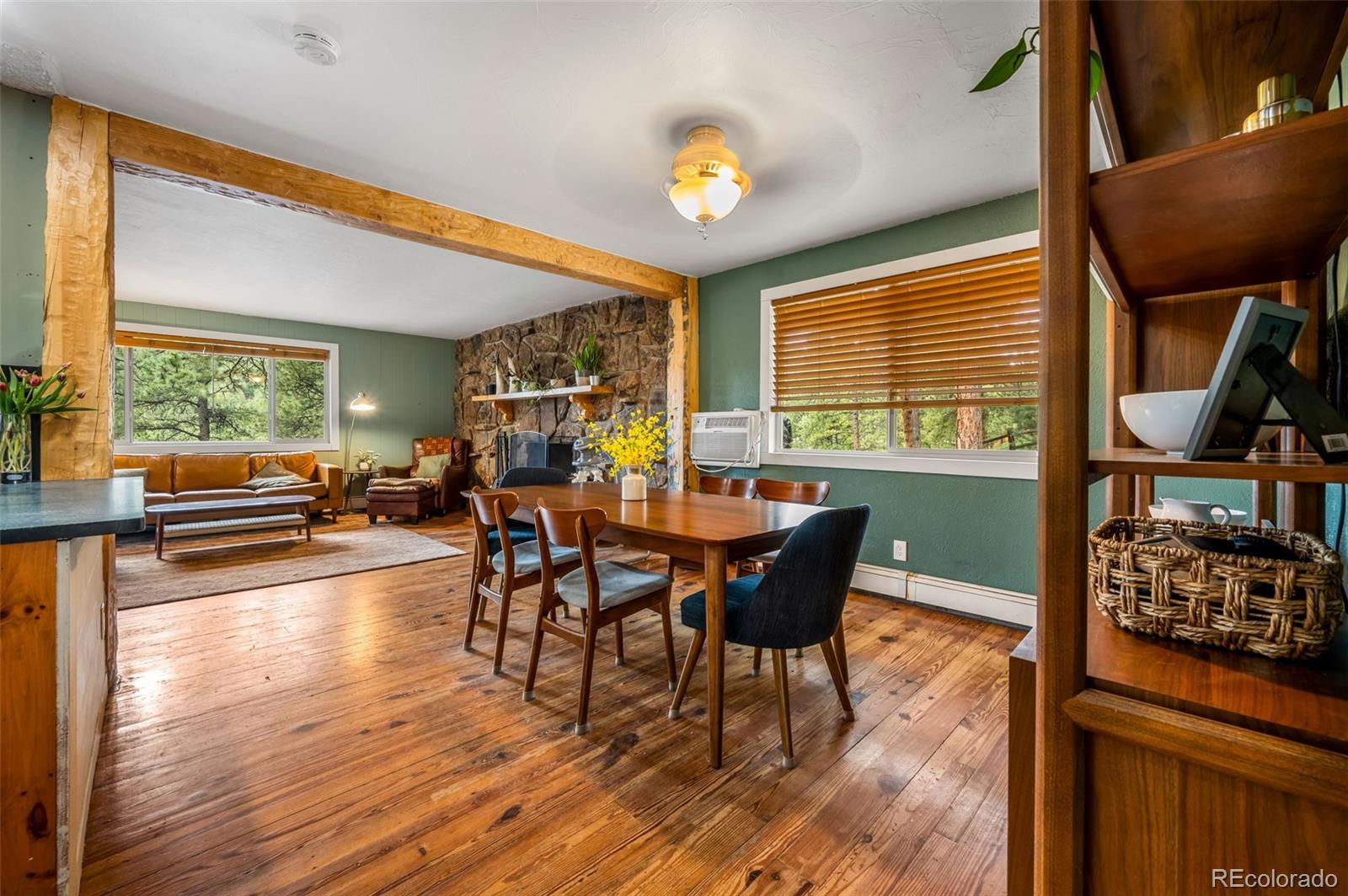 30315 Lone Spruce Road Evergreen, CO 80439 - Photo 10 of 48 a view of a dining room with furniture window and wooden floor