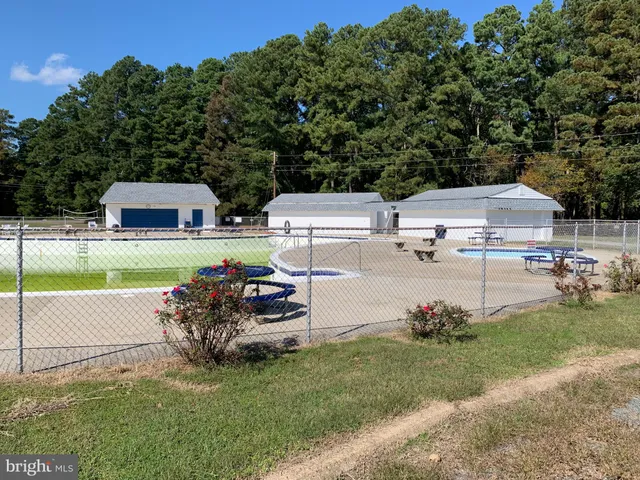 a view of yard with swimming pool and trees