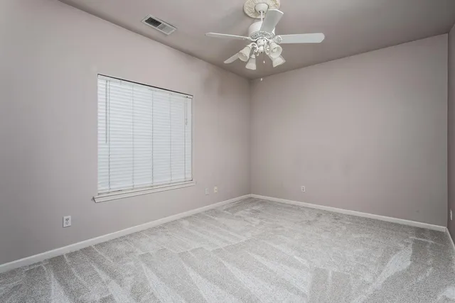 a bathroom with a granite countertop sink mirror vanity and toilet