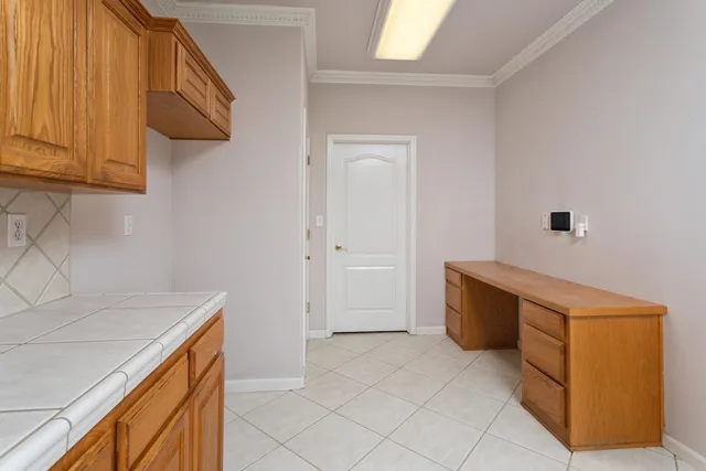 a kitchen with cabinets and window