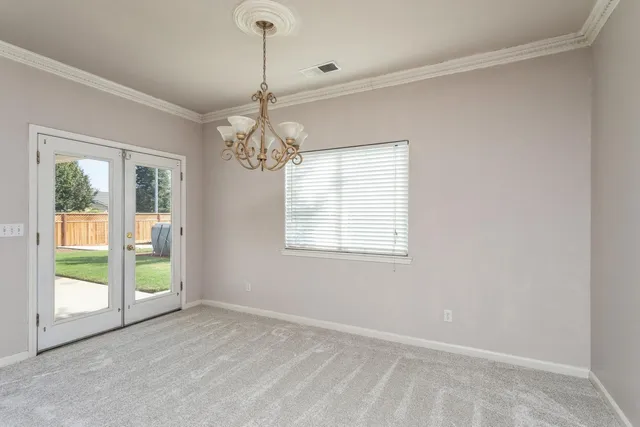 an empty room with windows and cabinet