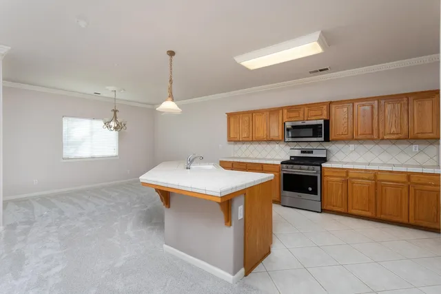 an empty room with cabinet and ceiling fan