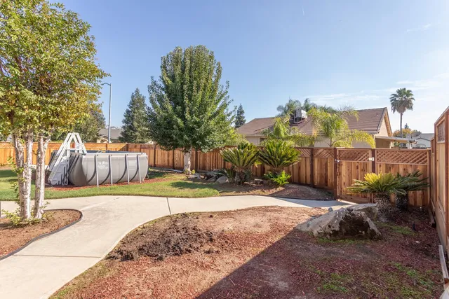 a view of a backyard with sitting area