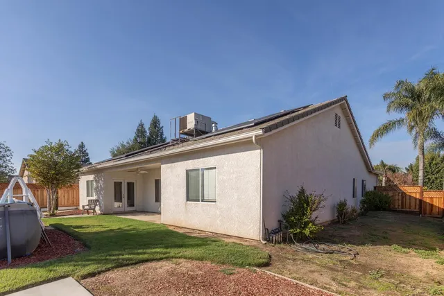 a view of a backyard with wooden fence