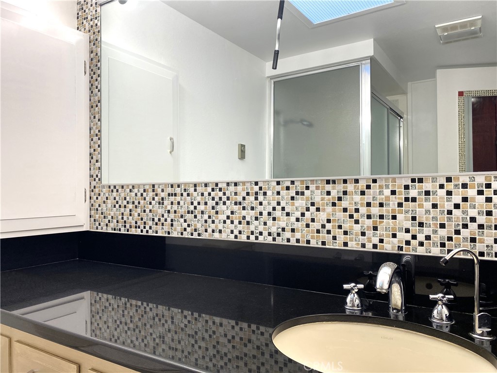 1361 Wee Burn Road Seal Beach, CA 90740 - Photo 12 of 13 a bathroom with a sink and a mirror
