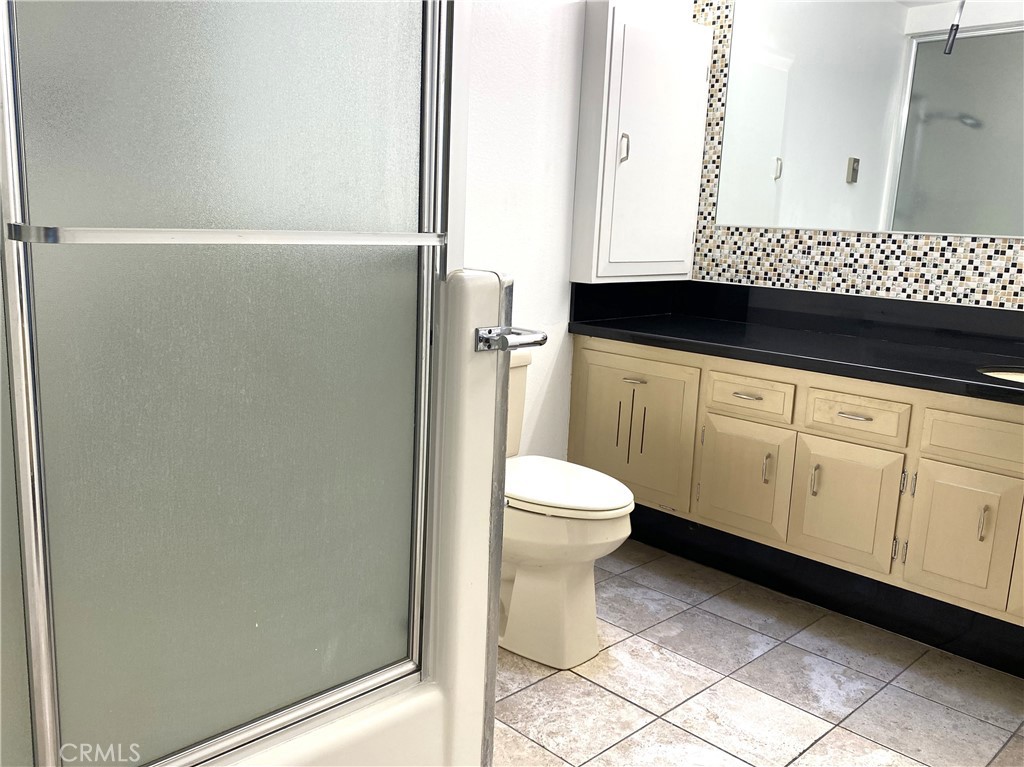 1361 Wee Burn Road Seal Beach, CA 90740 - Photo 13 of 13 a bathroom with a sink a toilet and a mirror