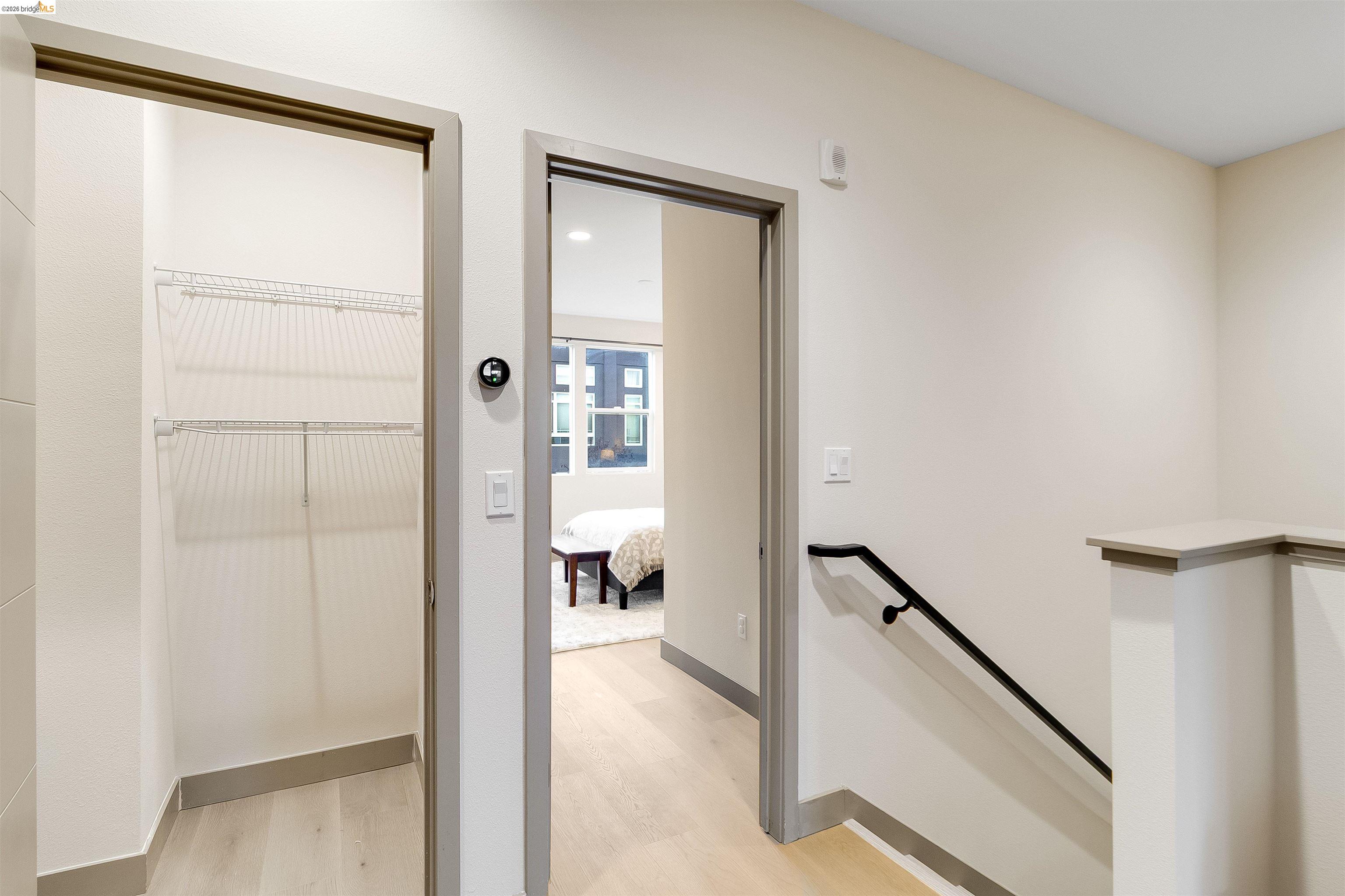 1357 Pullman Way Oakland, CA 94607 - Photo 27 of 37 Interior hallway with light wood-finish flooring, white walls, and light gray trim