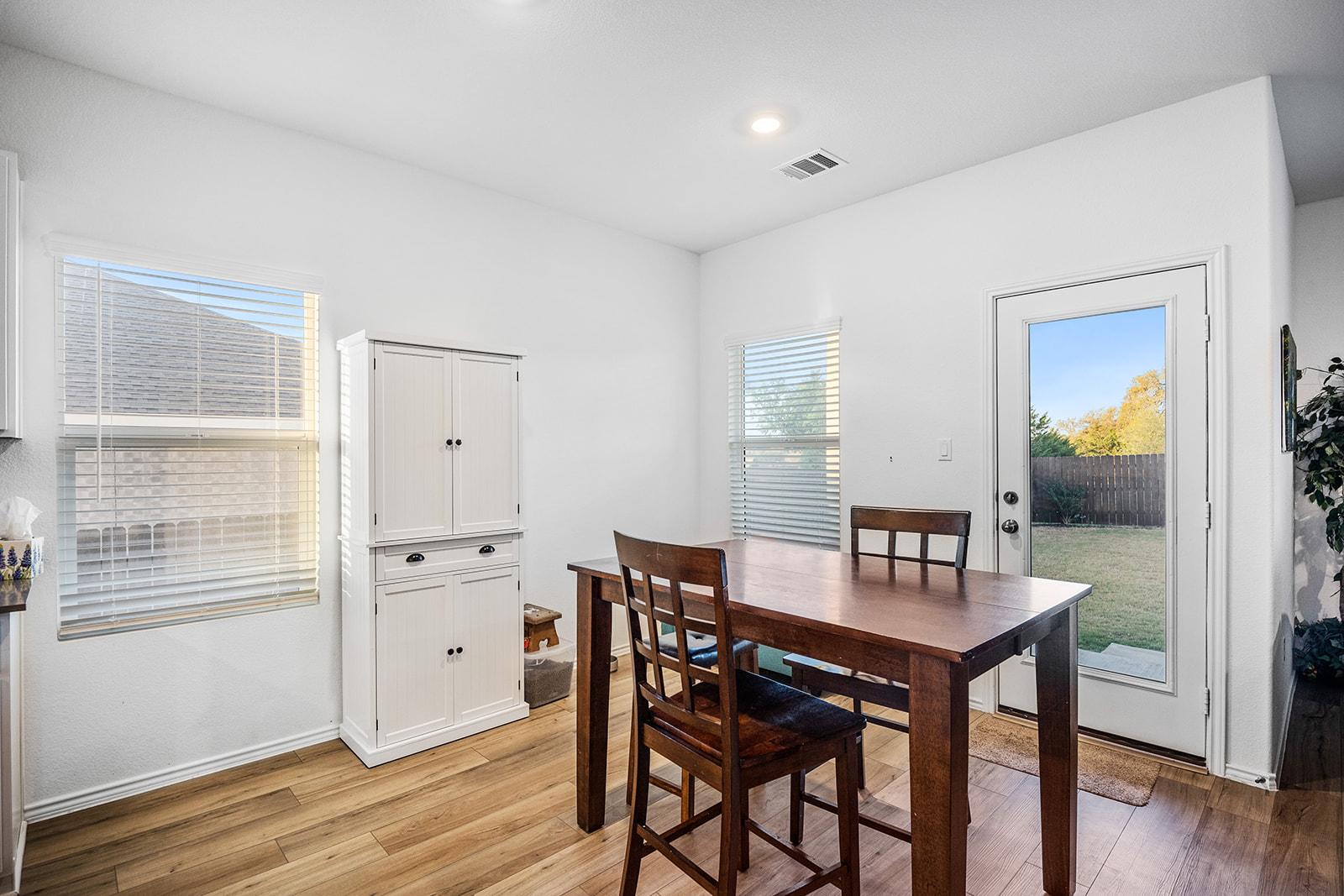 1909 Four Waters Loop Georgetown, TX 78628 - Photo 11 of 35 a view of a dining room with furniture and wooden floor