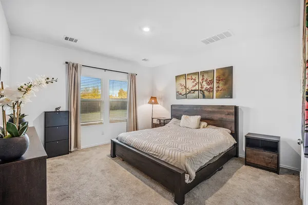 a living room with lots of baby toys and dresser