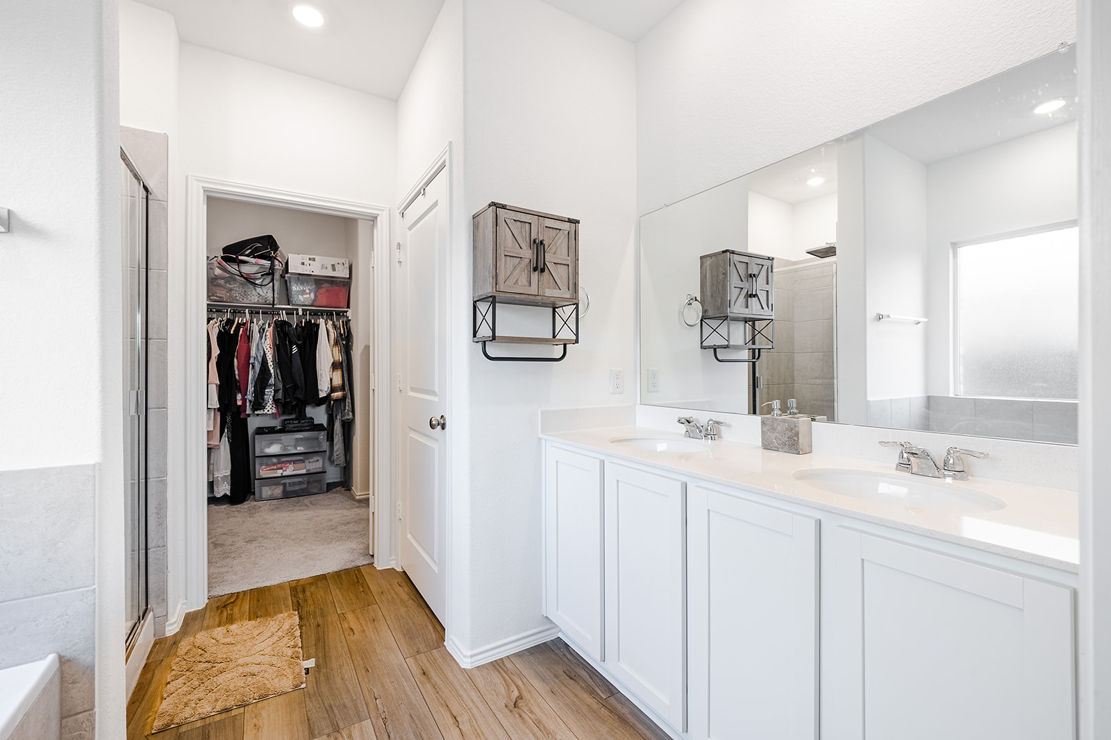 1909 Four Waters Loop Georgetown, TX 78628 - Photo 16 of 35 a en suite bathroom with a double vanity sink and a mirror