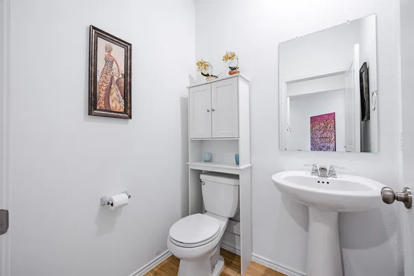 a bathroom with a double vanity sink toilet mirror and shower