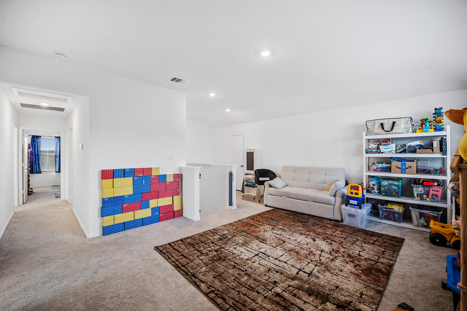 1909 Four Waters Loop Georgetown, TX 78628 - Photo 20 of 35 a living room with lots of baby toys and dresser