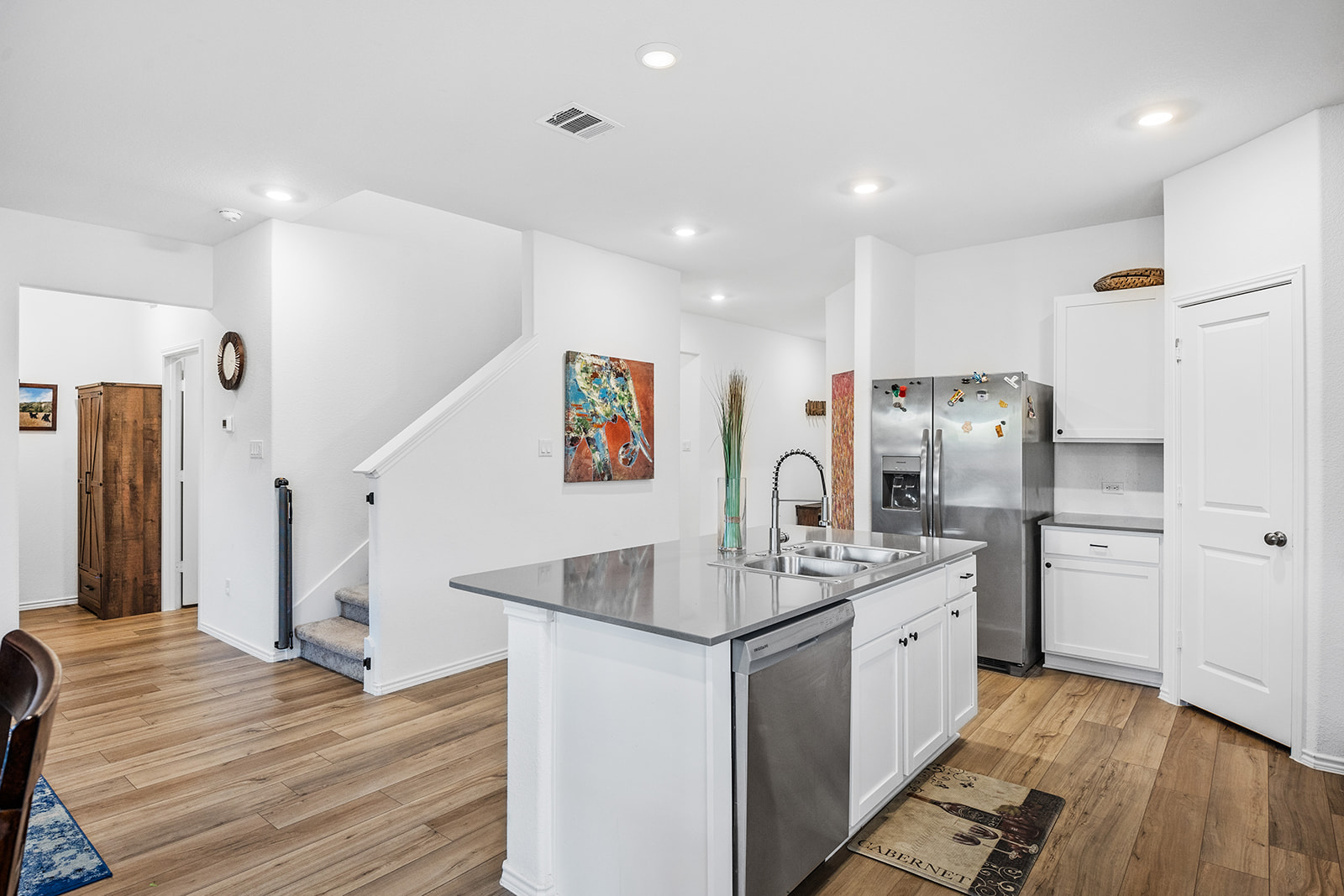 1909 Four Waters Loop Georgetown, TX 78628 - Photo 9 of 35 a kitchen with stainless steel appliances kitchen island granite countertop a refrigerator and a sink