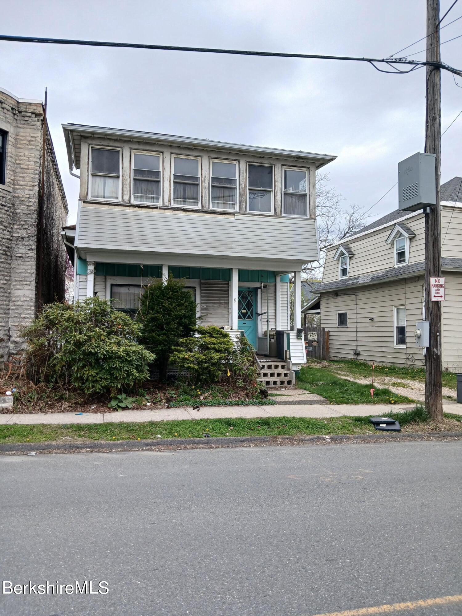 9 Lincoln Street Pittsfield, MA 01201 - Photo 1 of 1 a front view of a house with a garden and parking