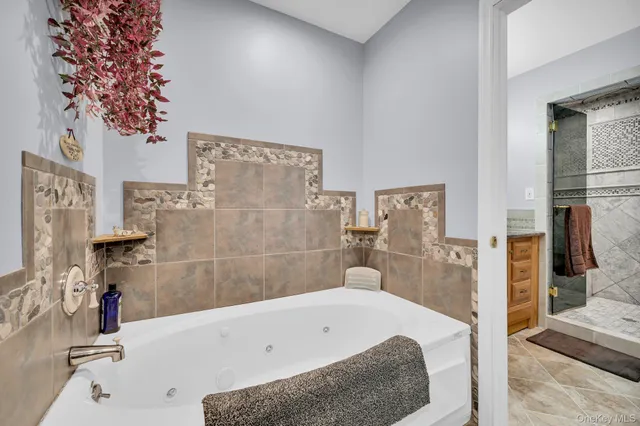 a bathroom with a tub a sink and a shower