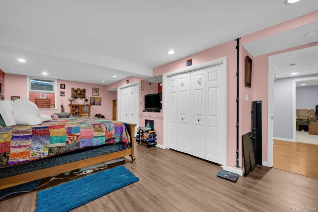 a bedroom with bed and wooden floor