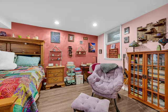 a bedroom with furniture and a wooden floor