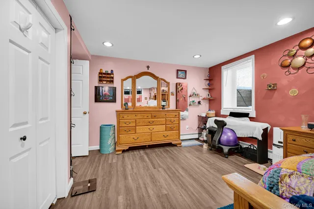 a bedroom with furniture and wooden floor