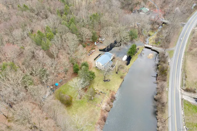 a aerial view of a house with a yard and swimming pool