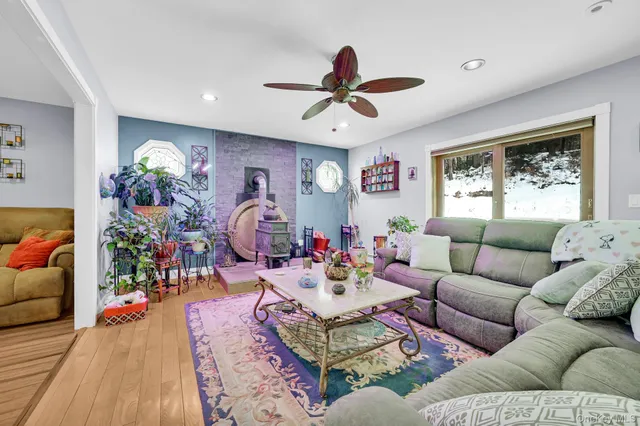 a living room with furniture potted plant and a window