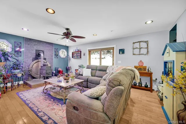 a living room with furniture a chandelier and a flat screen tv