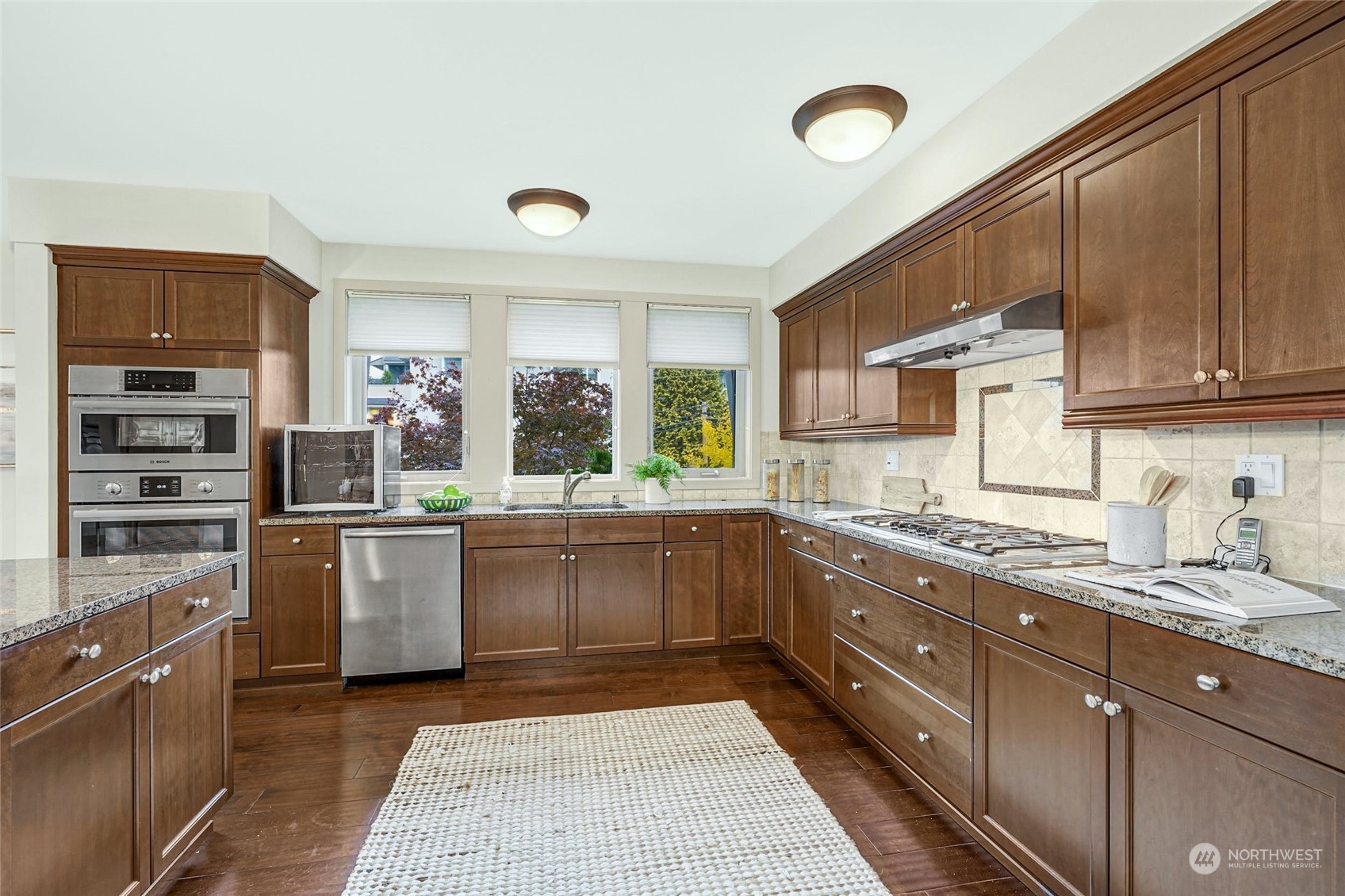 316 Walnut Street, Unit 201 Edmonds, WA 98020 - Photo 15 of 29 a kitchen with stainless steel appliances granite countertop a stove sink and cabinets