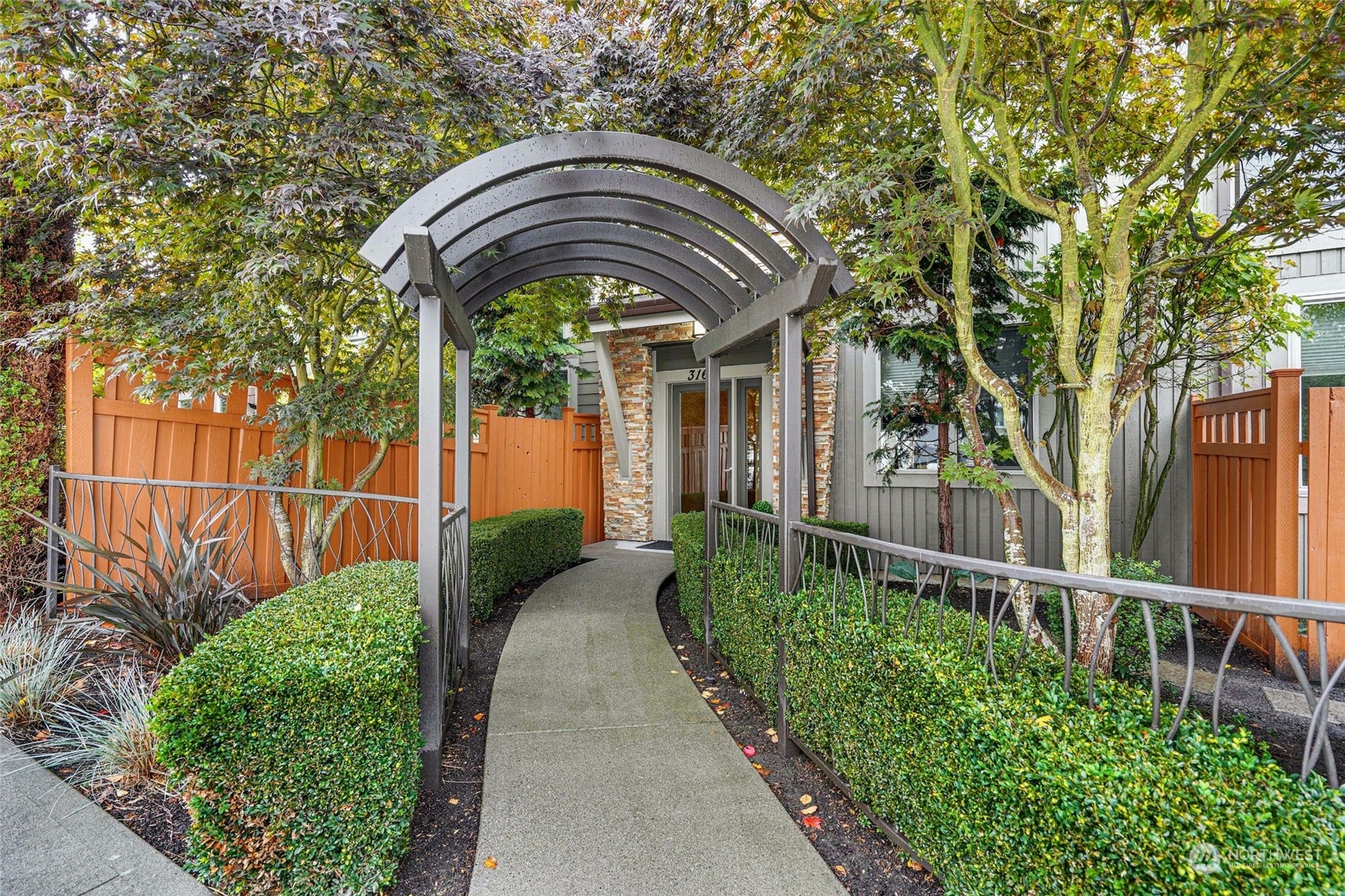 316 Walnut Street, Unit 201 Edmonds, WA 98020 - Photo 2 of 29 a front view of a house with a garden