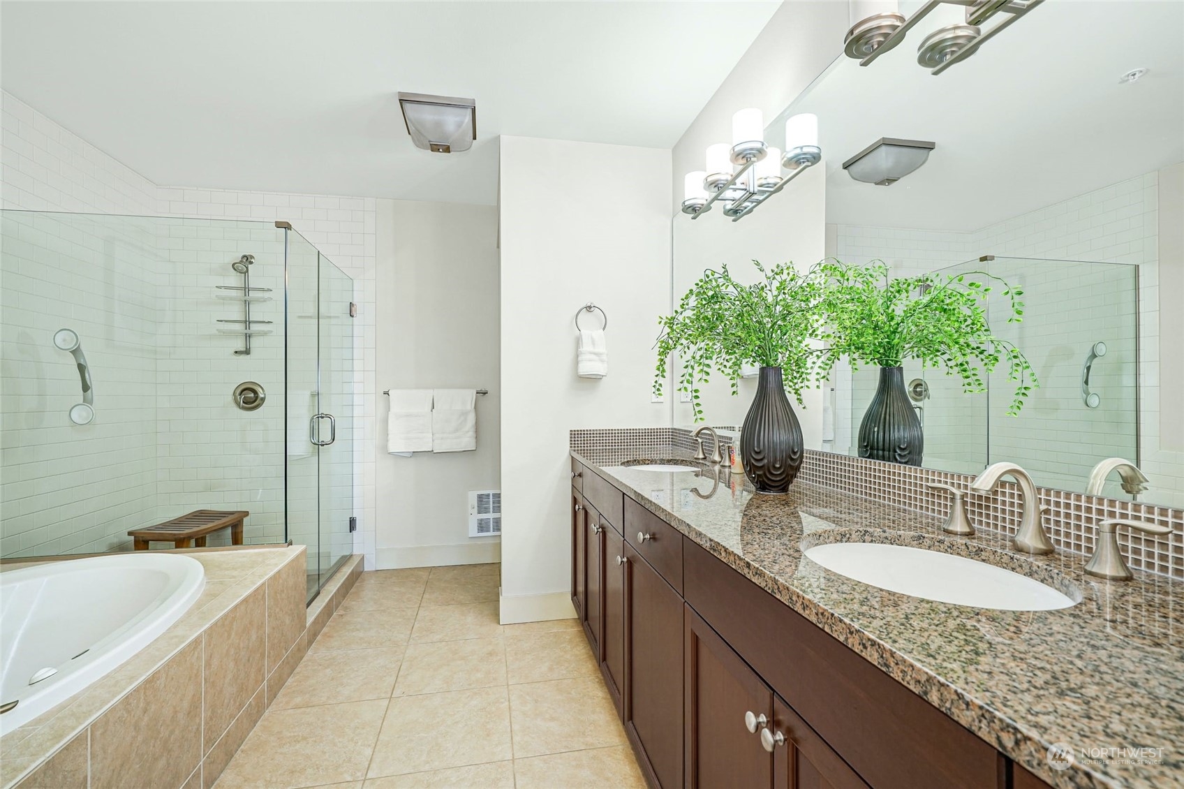 316 Walnut Street, Unit 201 Edmonds, WA 98020 - Photo 21 of 29 a bathroom with a granite countertop sink a large mirror and a bathtub