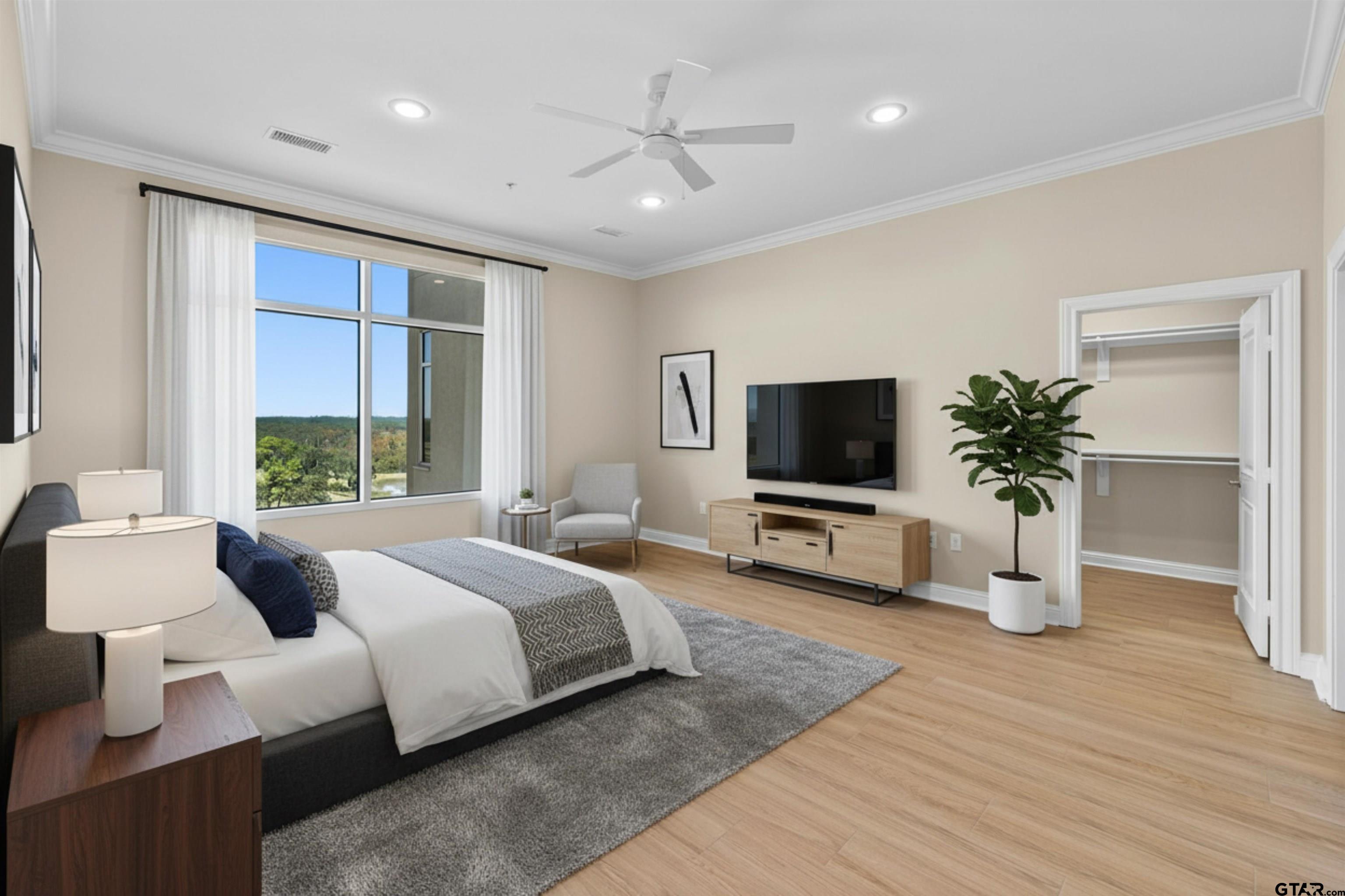 2801 Wexford Drive Tyler, TX 75709 - Photo 20 of 31 a bedroom with a bed a flat screen tv and a couch