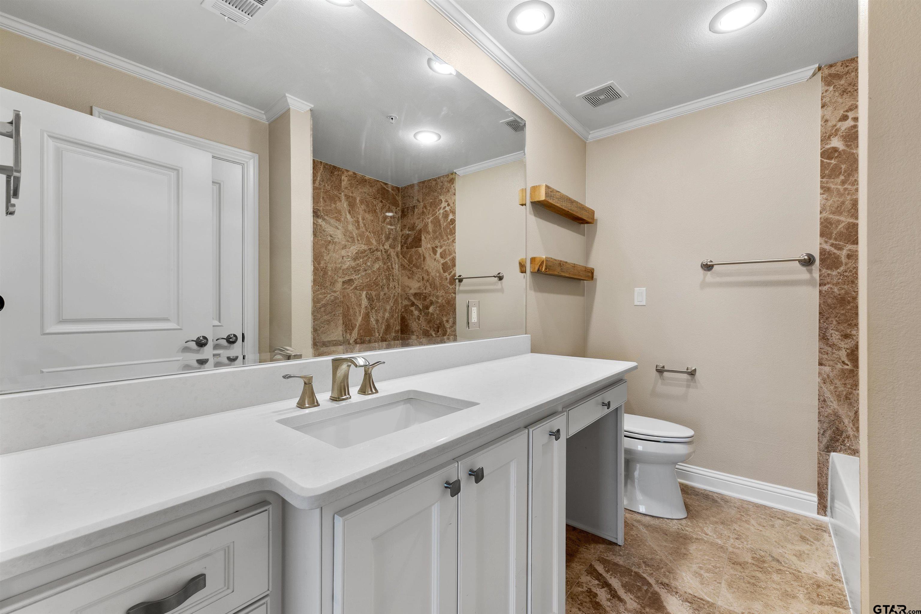 2801 Wexford Drive Tyler, TX 75709 - Photo 2 of 31 a bathroom with a sink and a mirror